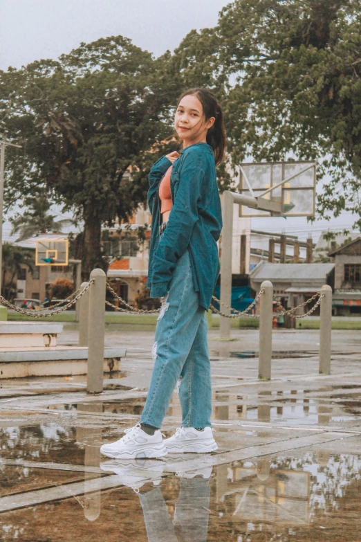 a girl with an umbrella standing in a dle