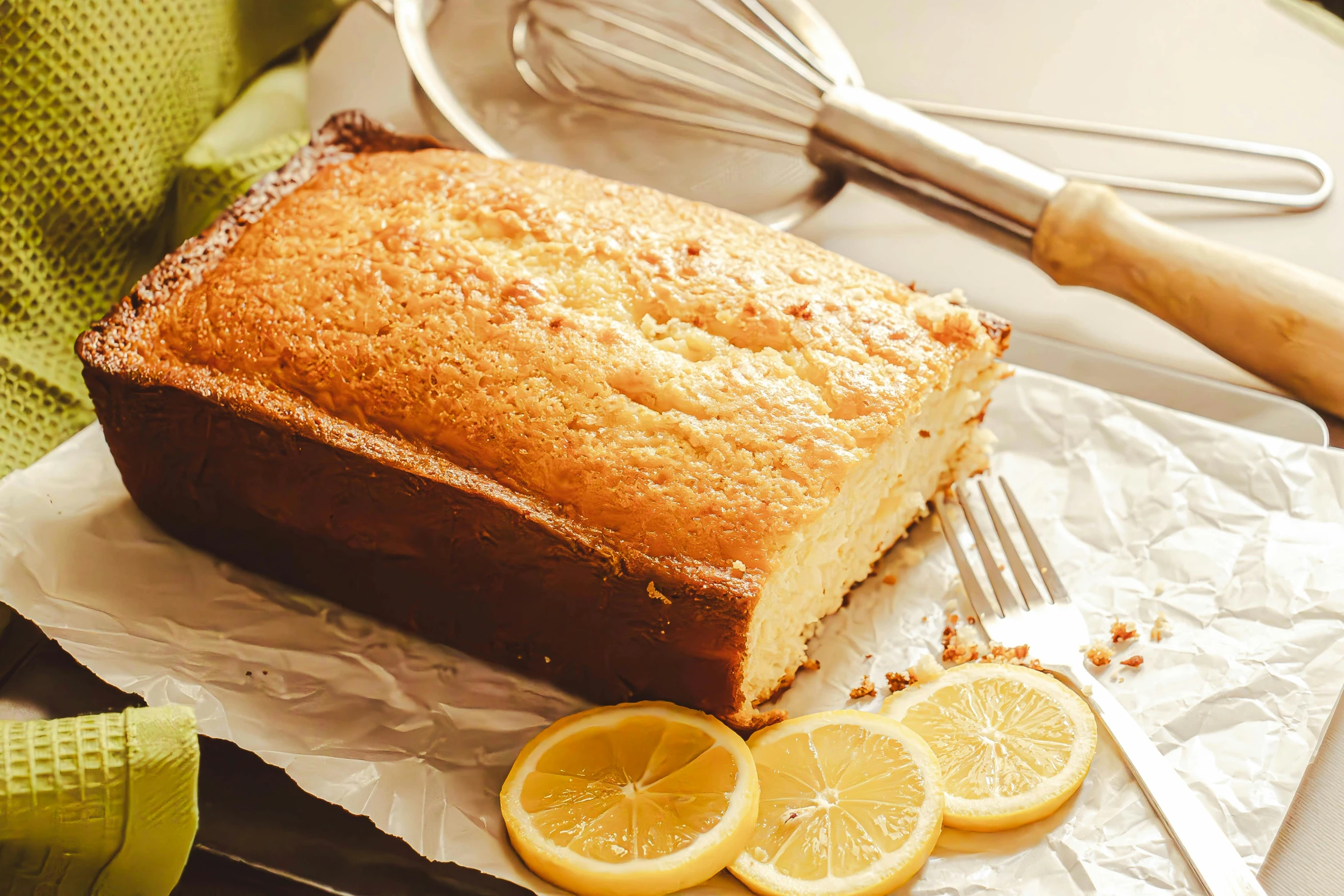 a loaf of lemon bread with slices cut out of it