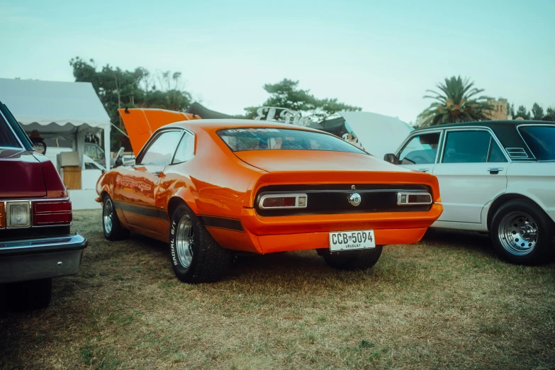 three cars parked next to each other on grass