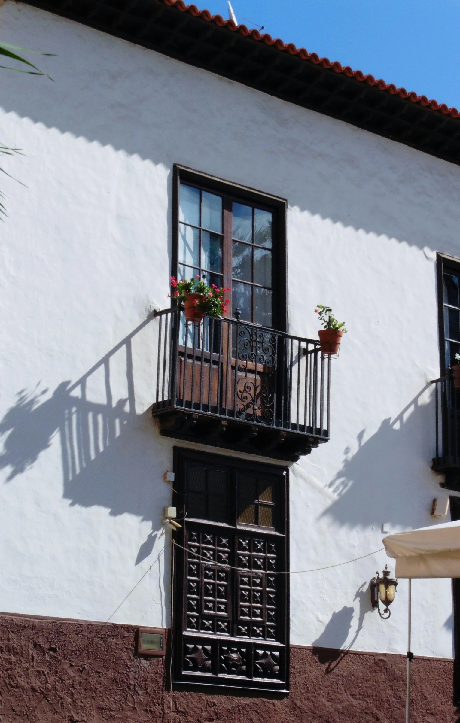 an empty patio next to a building with two balconies on each balcony