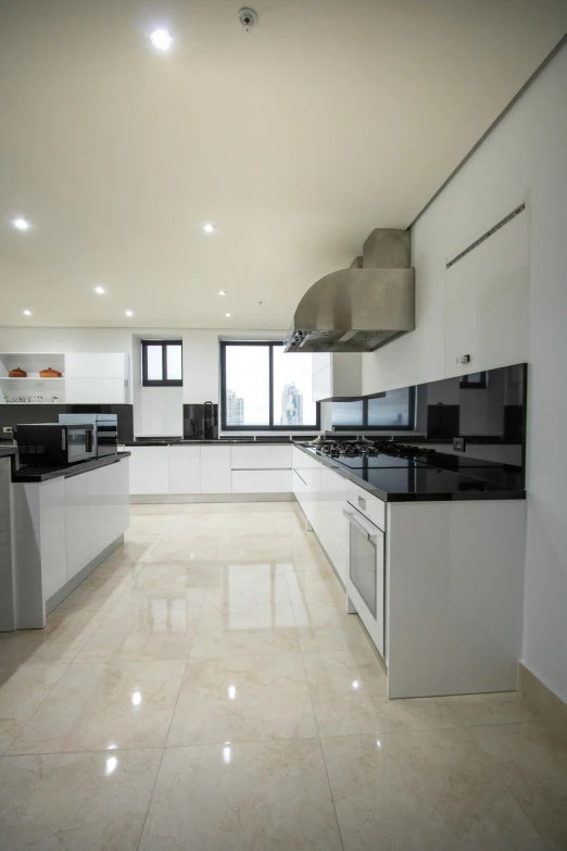 modern white kitchen with black and silver appliances