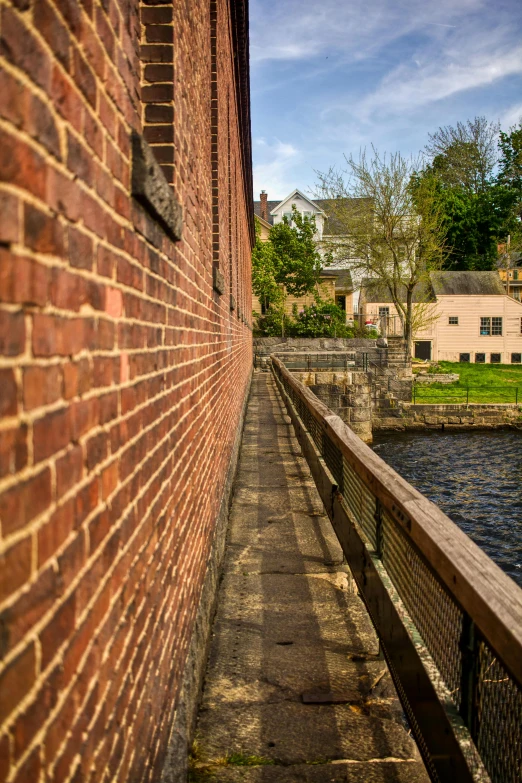 a brick building and a river next to it