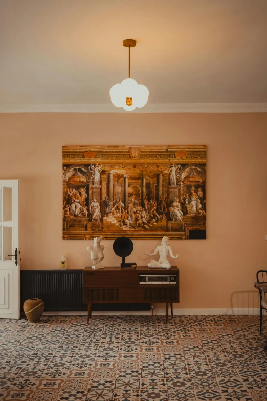 large ornate painting with antique artwork on wall