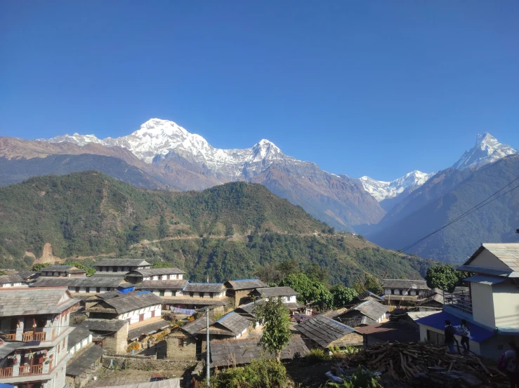 snow covered mountains rise over the small village