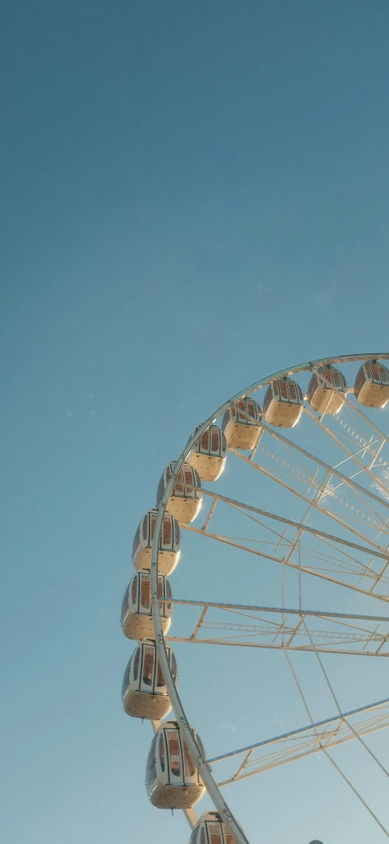 a ferris wheel on a clear day in the sky