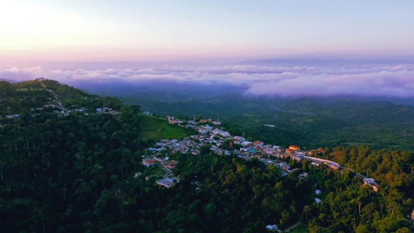 an aerial view of a town and a large mountain