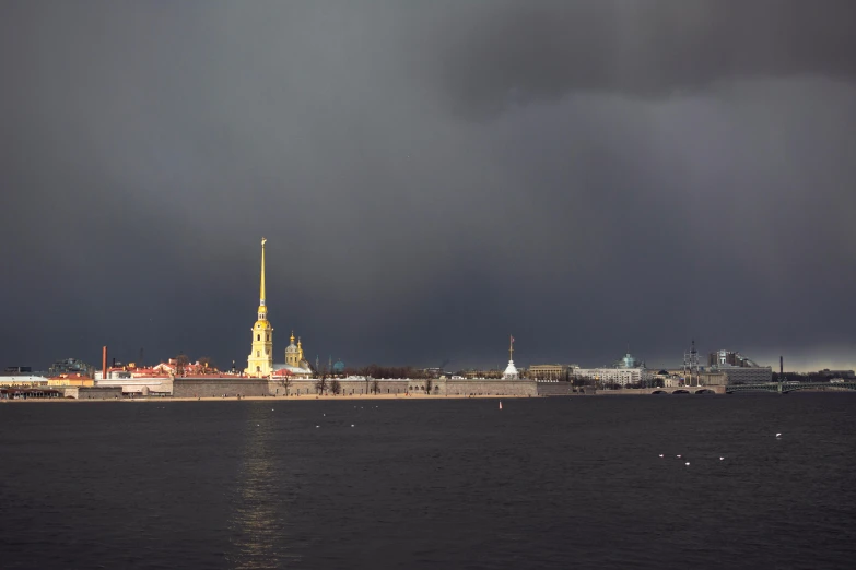 stormy skies surround a large city on the water