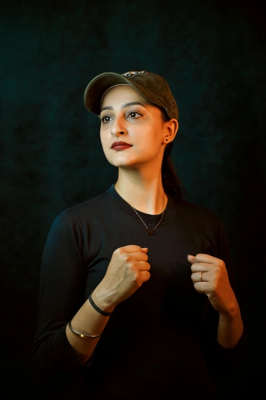 a woman in a baseball cap is posing for a picture