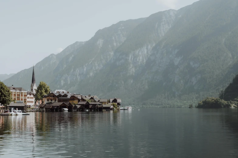 an island with houses on it and mountains behind