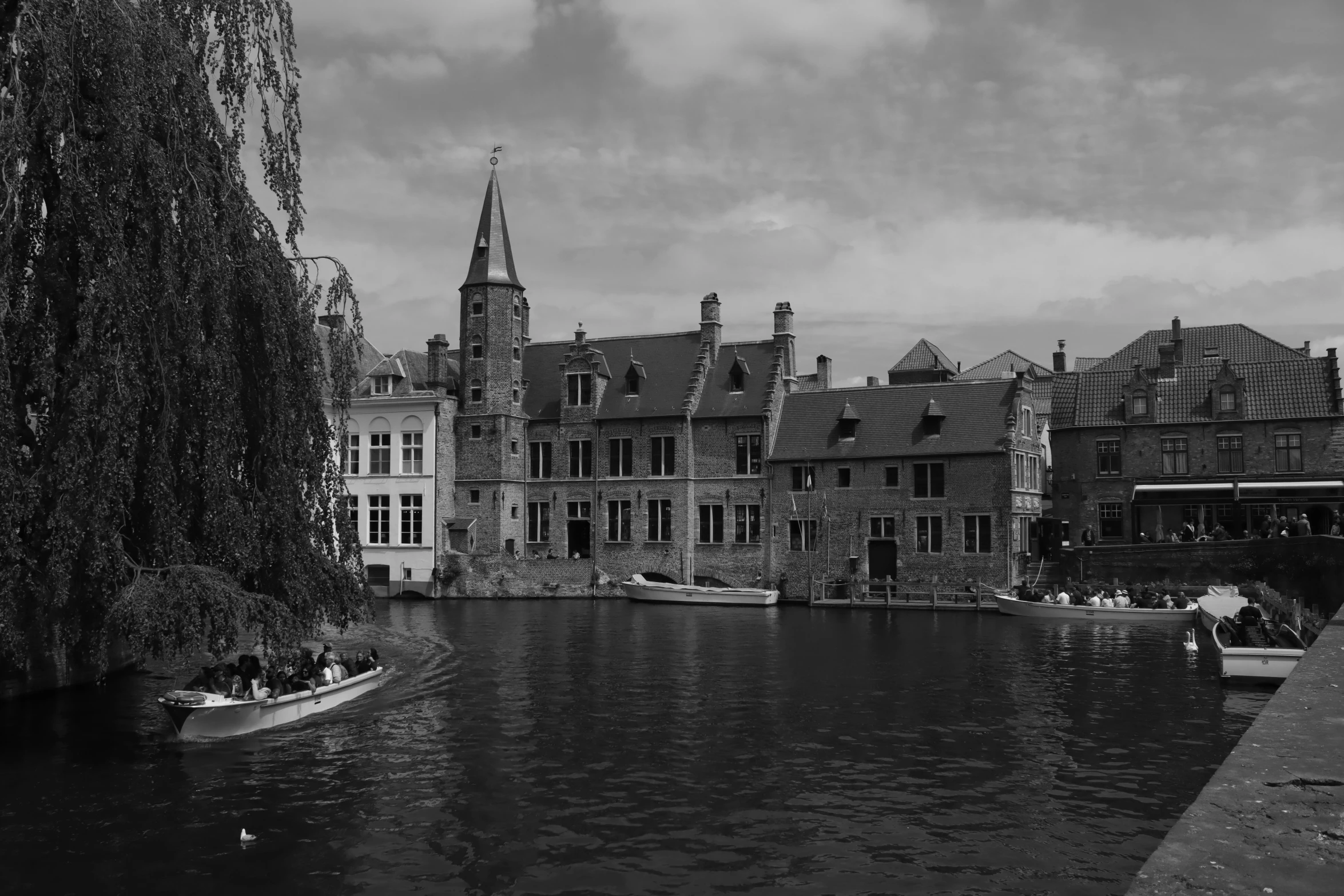 old buildings are on the river next to a small boat