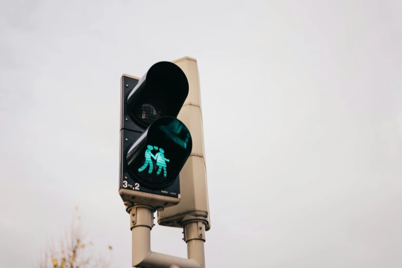 the traffic light has an green signal with people running