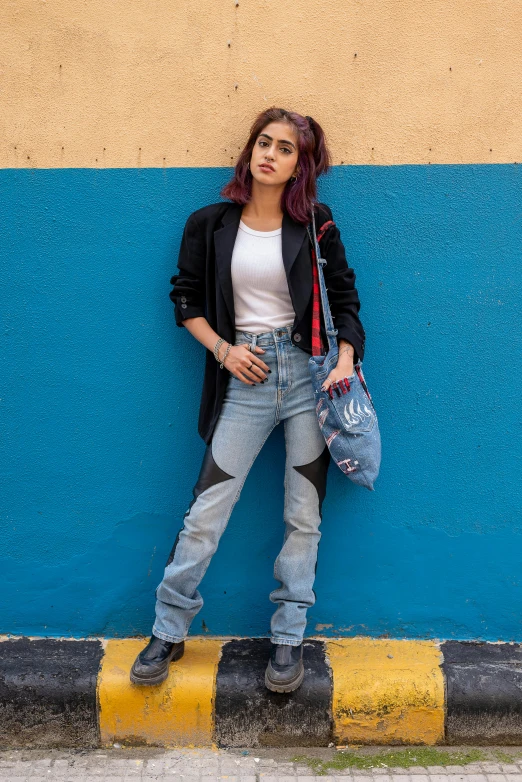 the  leaning against the wall holding her purse