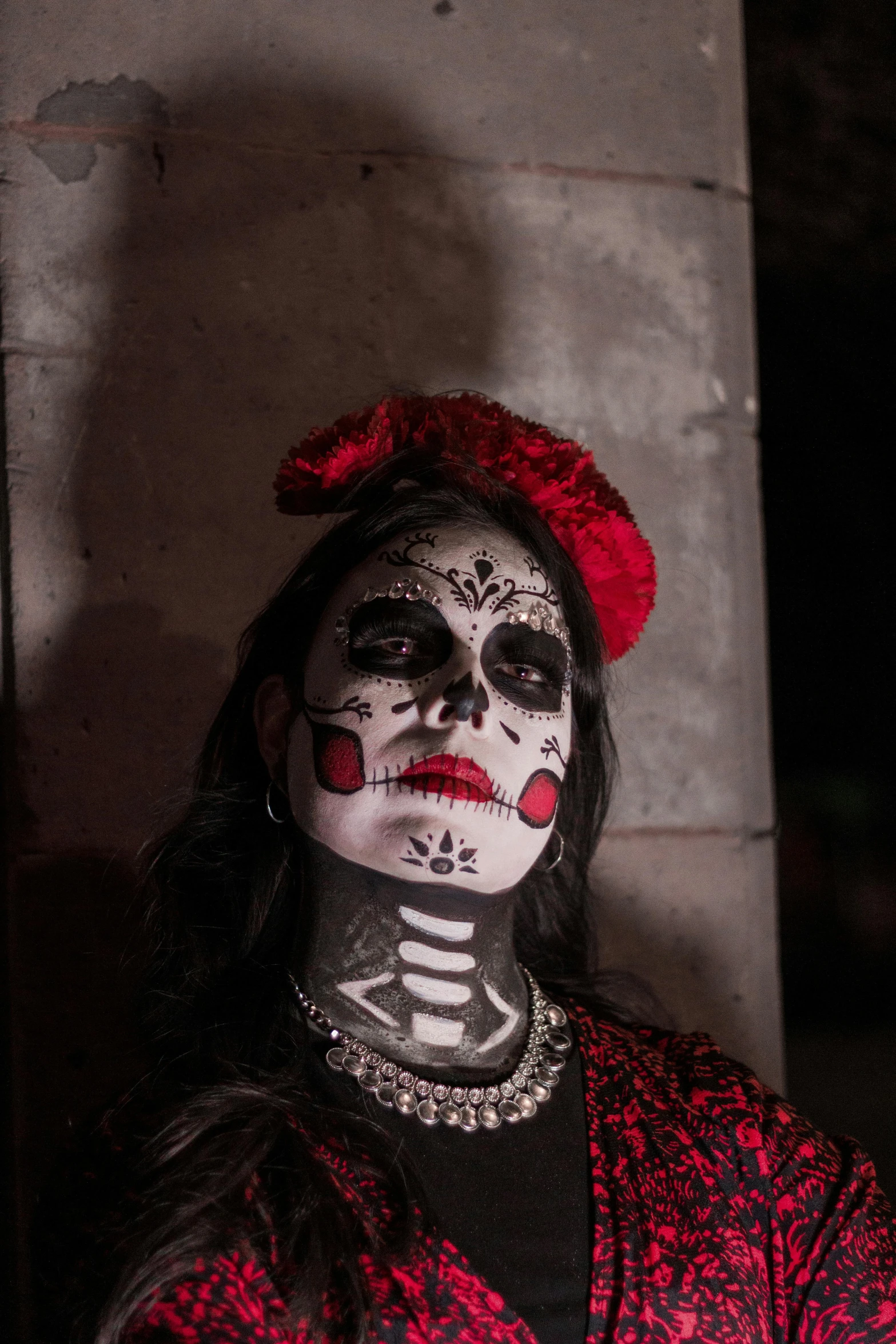 a woman with skull makeup is wearing a costume