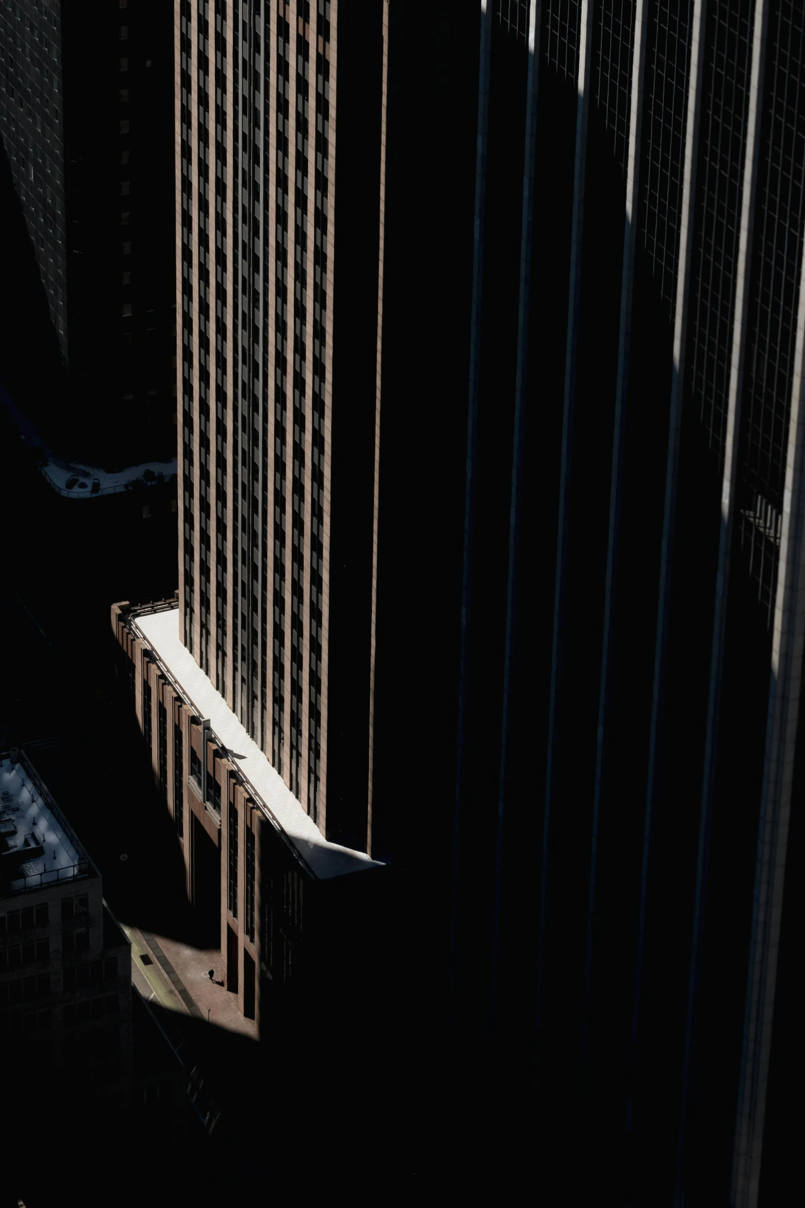 aerial view of tall buildings and parking lot at dusk