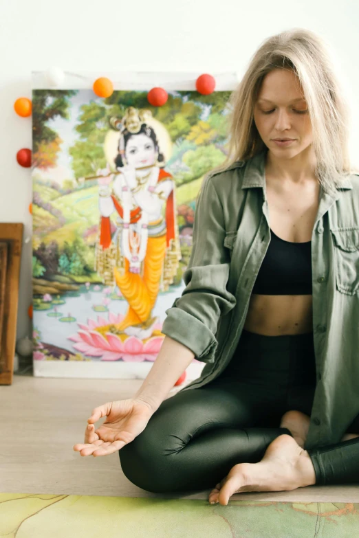 the woman is practicing yoga in her home