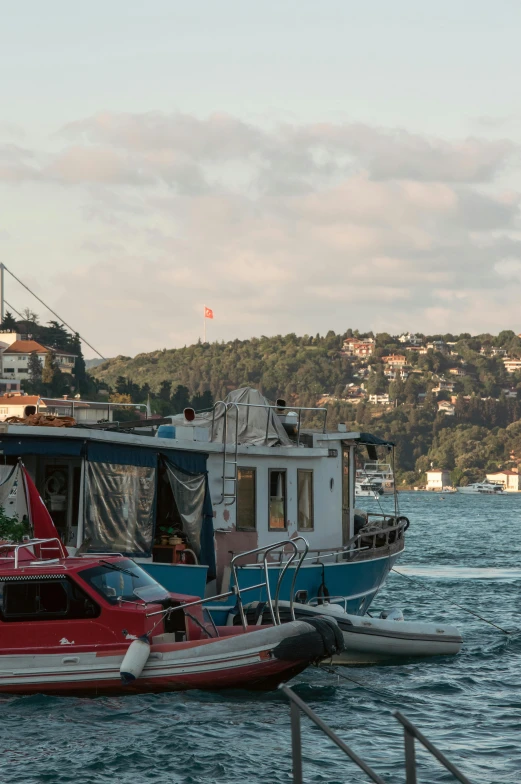 a large red boat next to a larger blue boat on the water