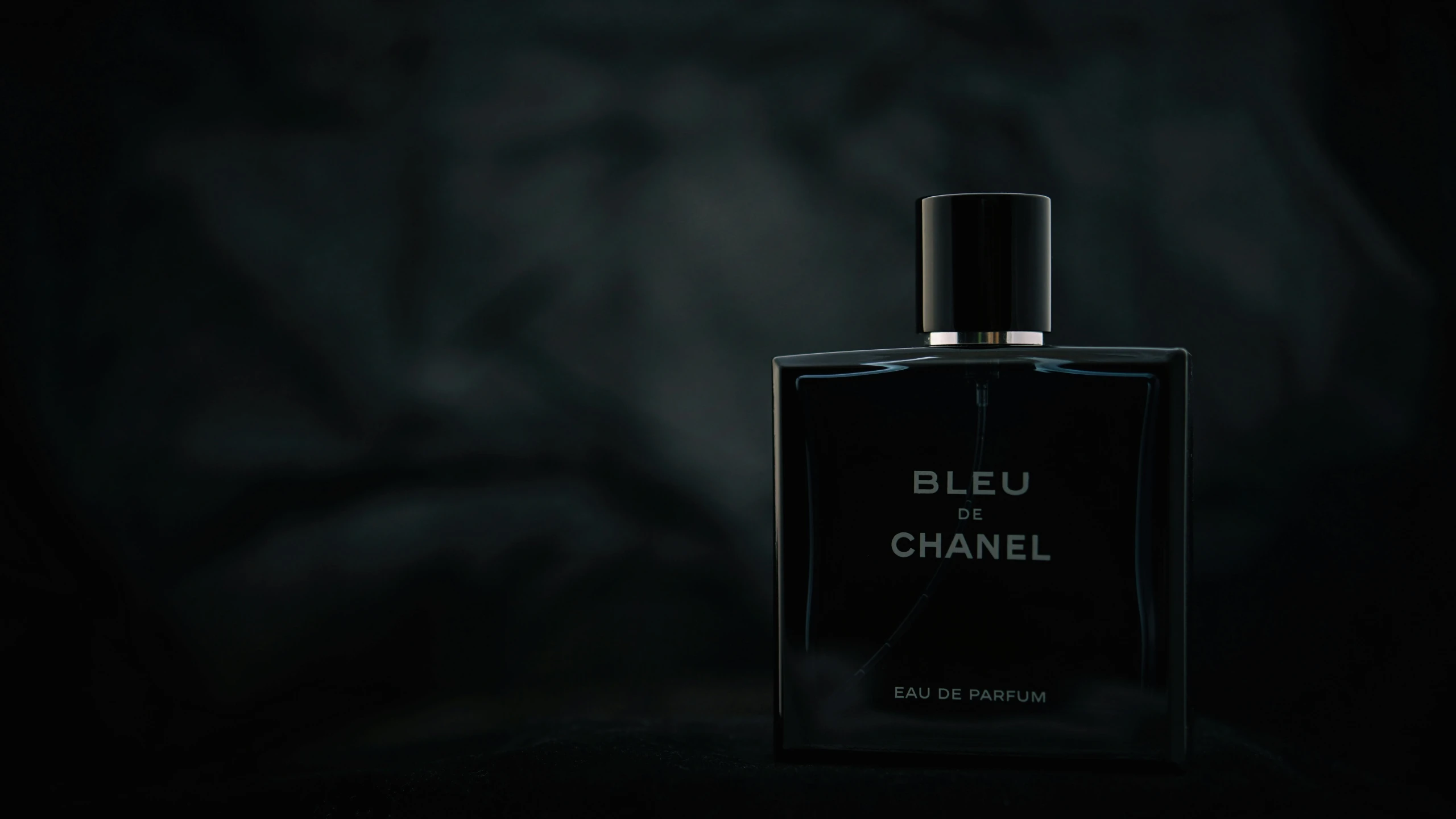 a bottle of perfume sitting in the dark