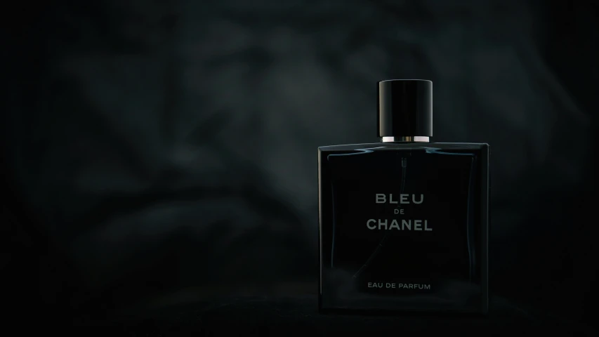 a bottle of perfume sitting in the dark