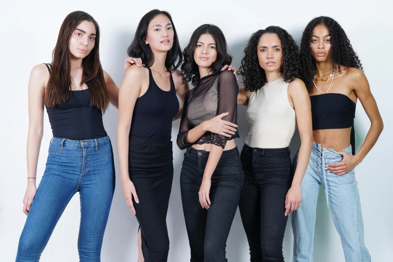 five women wearing dark clothing posing together