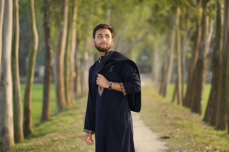 a man in the middle of an area that has many trees