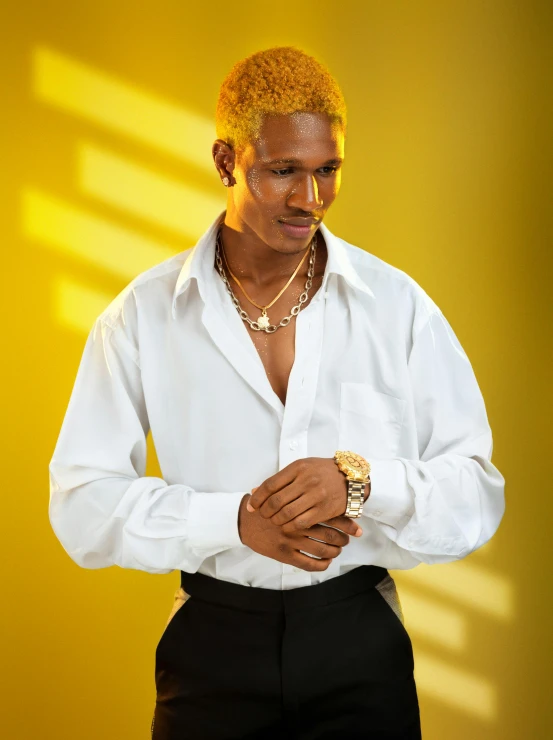 a male wearing a white shirt and black pants