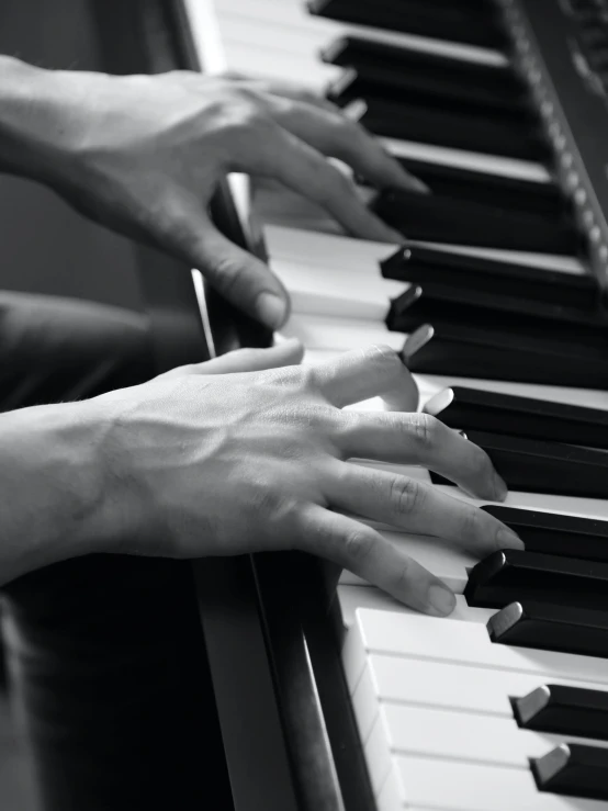 a person with their hand on the piano