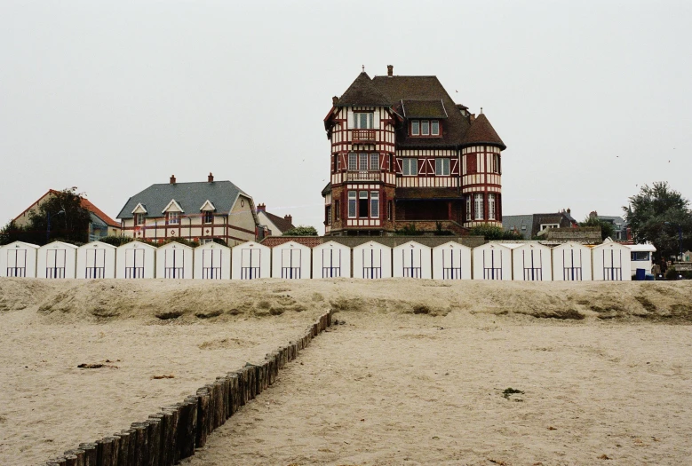 a tall building on a hill covered in sand