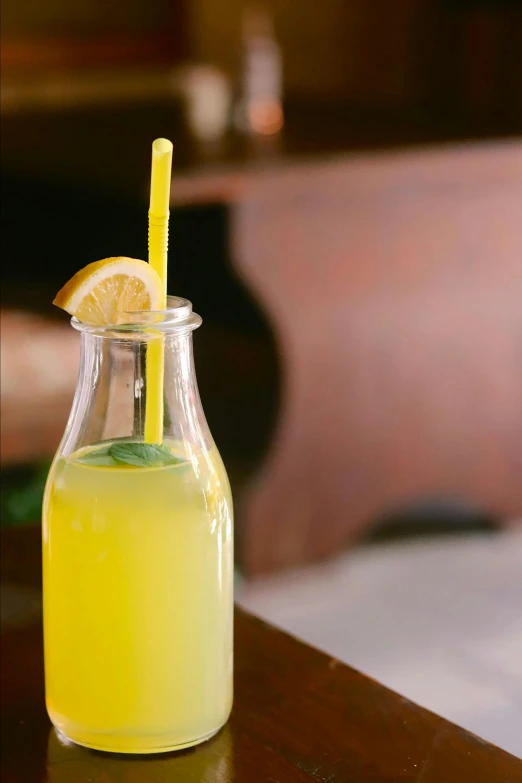 a glass container filled with lemonade and sliced lemon