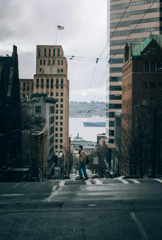 the man standing in the middle of an intersection with many buildings