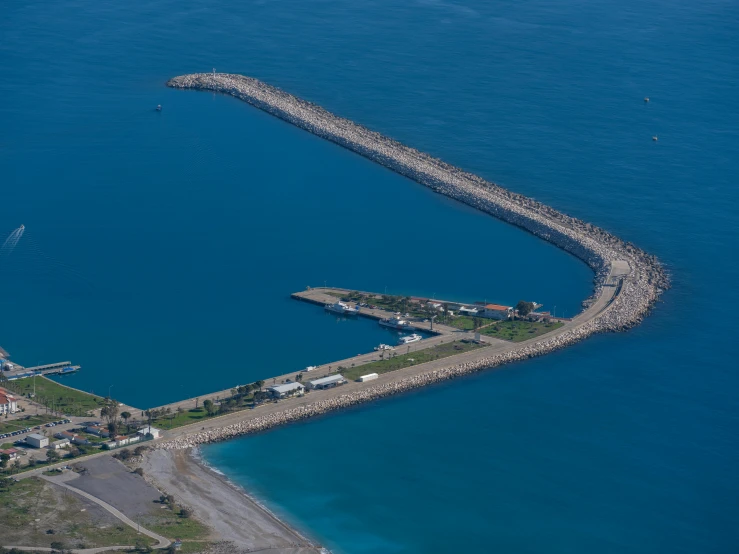 a large pier on the water next to an island