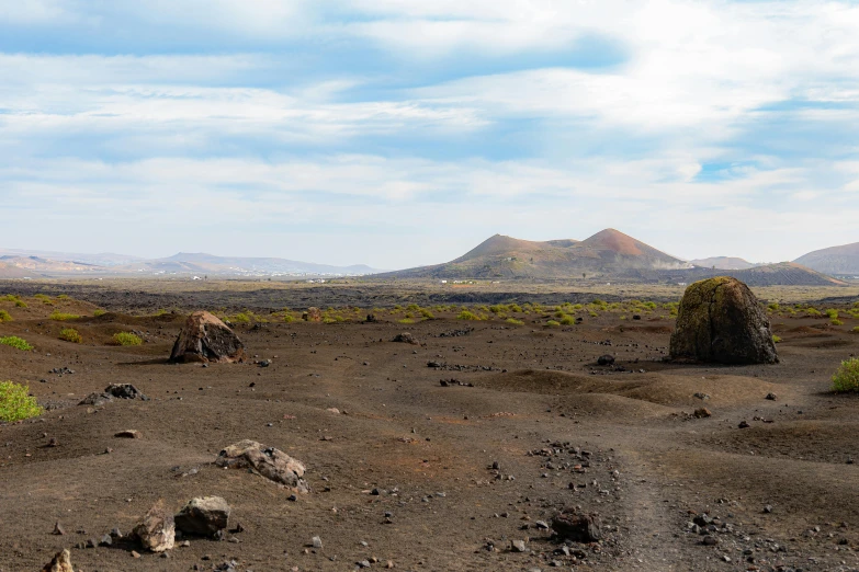 an area with rocks and green grass in the desert