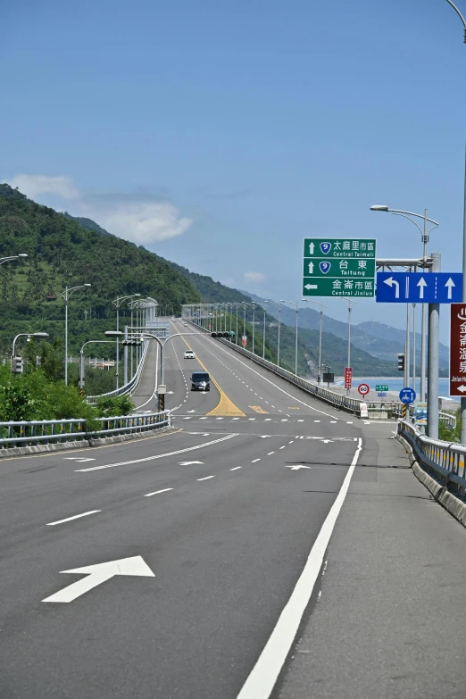 an interstate highway with a few green signs on the sides