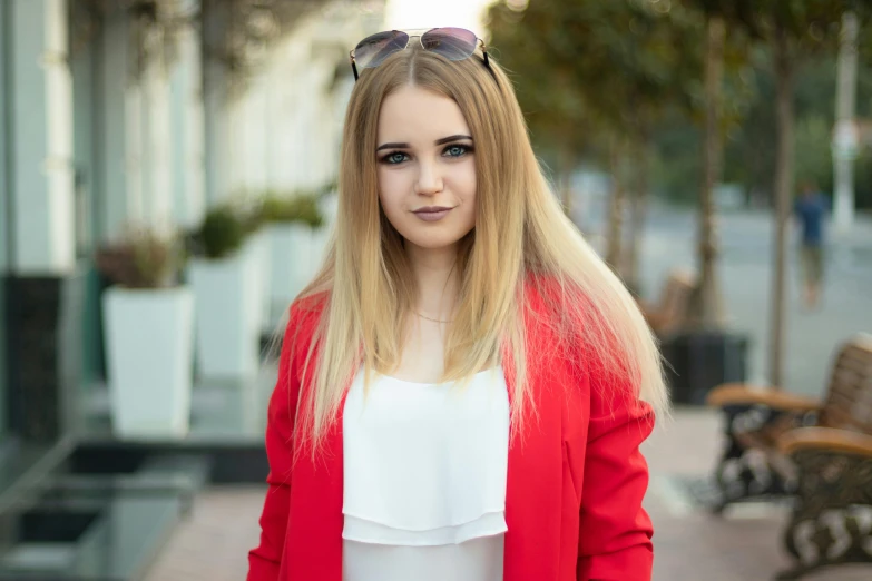 a woman with sunglasses is standing outside