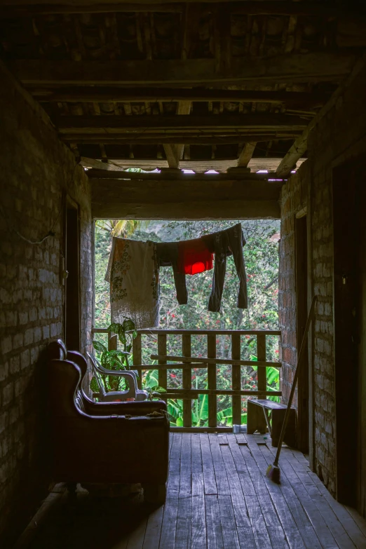 the balcony of an abandoned building, with a clothesline hanging out to dry