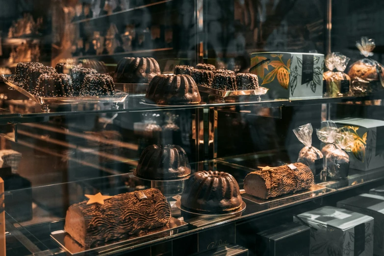 an assortment of cakes in a glass case