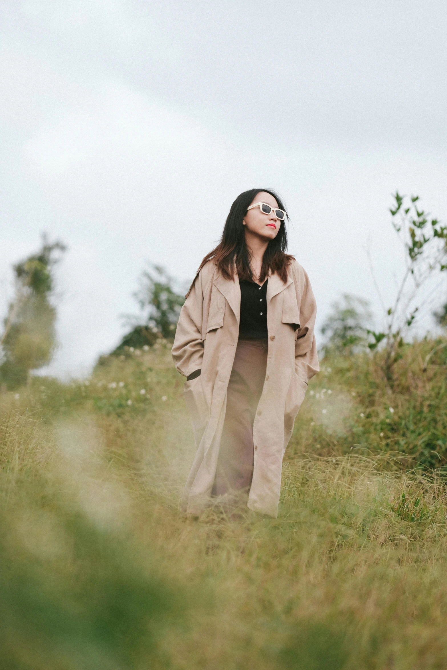 woman standing alone in a grassy field