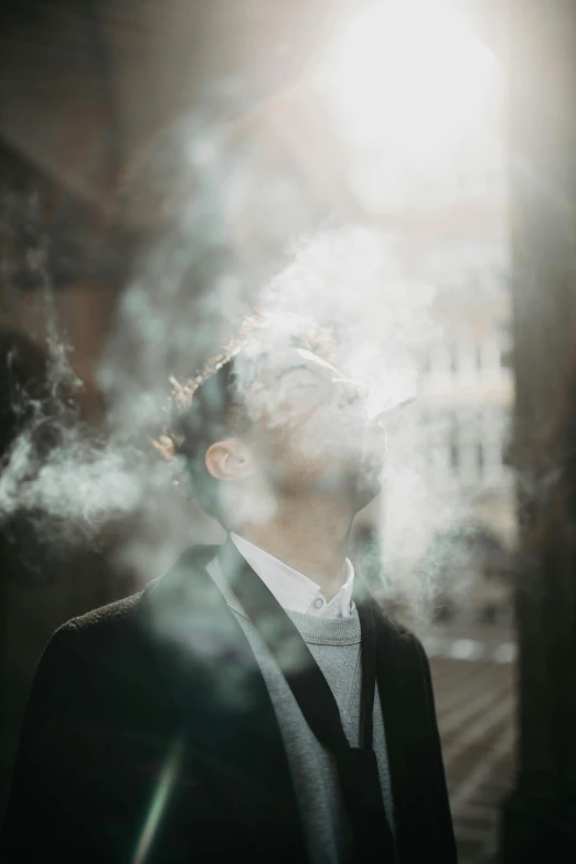 a man standing outside with his eyes closed and smoking