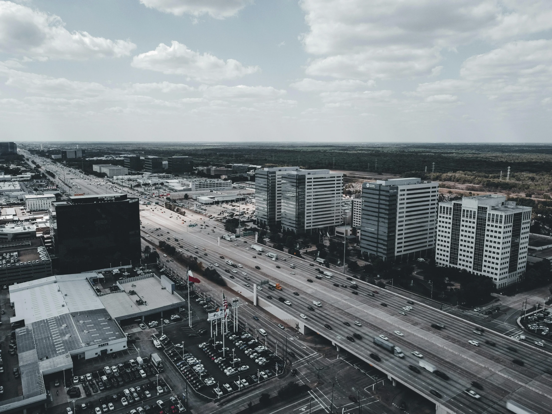 an aerial view of two roads in a city with tall buildings