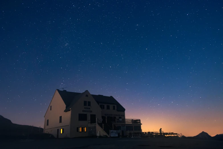 a house with the sky lit up by stars