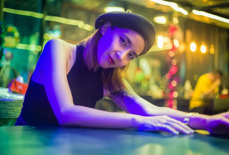 the young woman with a hat poses for a po