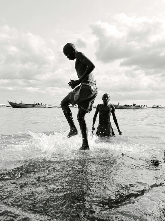 two people are in the ocean playing with soing