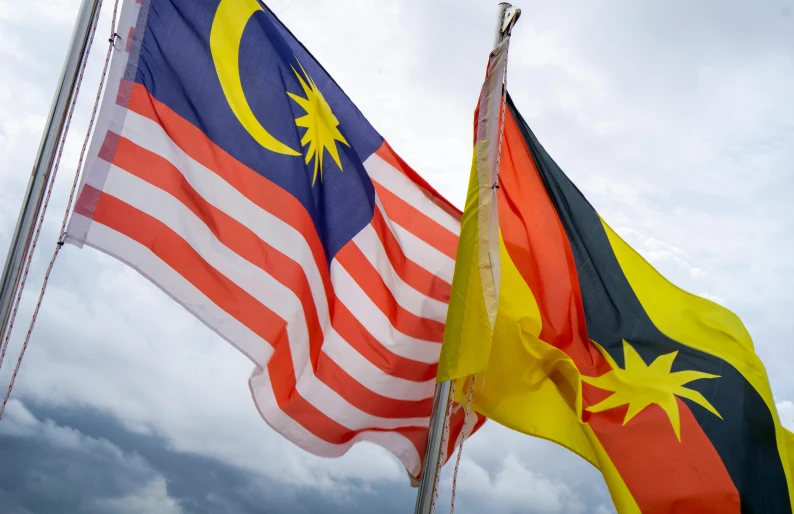 two malaysian and australian flags next to each other