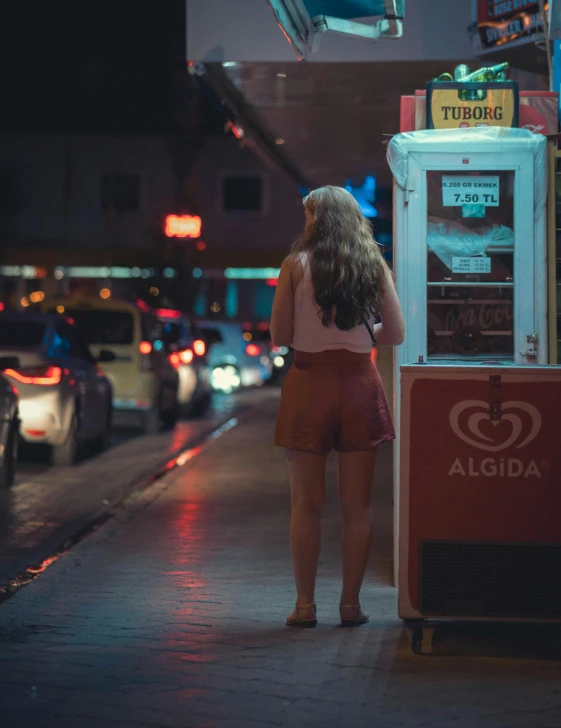 a girl is standing in front of the machine