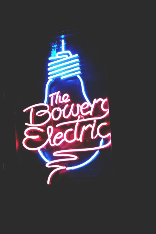 a neon sign in the middle of the night