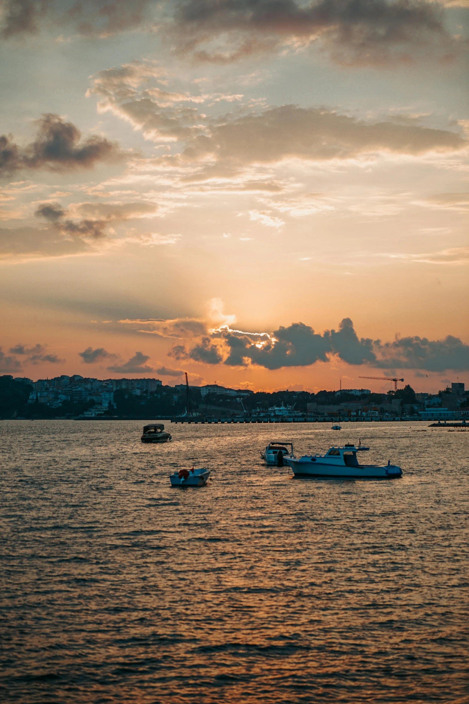 the boats are out on the water at sunset