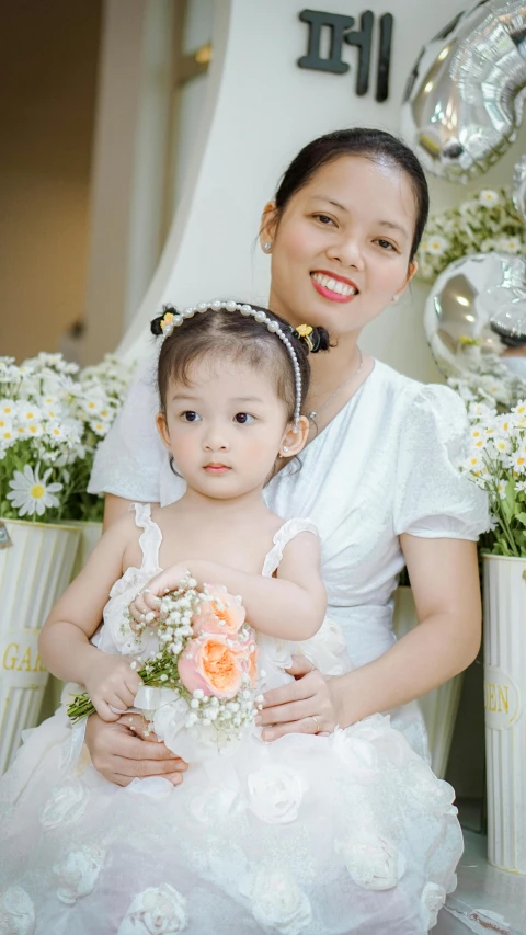 a woman holding a child while sitting down