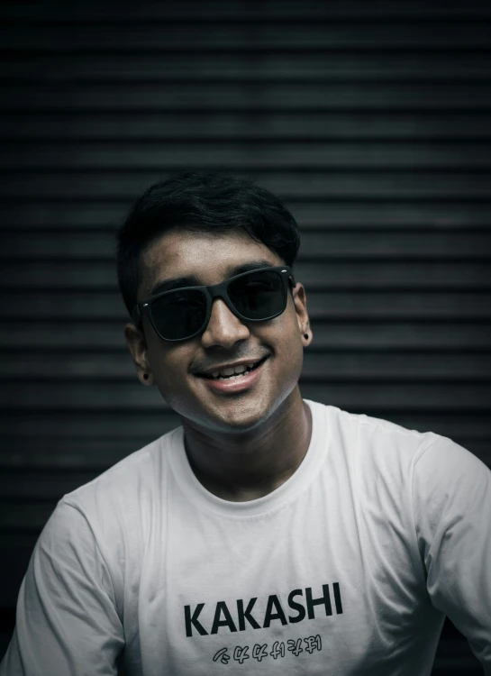 an image of a smiling man wearing sunglasses