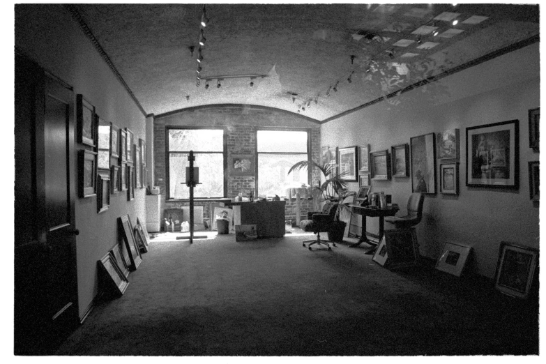 a hallway inside an apartment with pictures hanging up on the wall