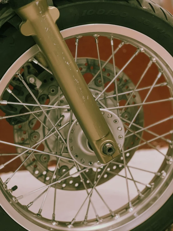 a motorcycle wheel with spokes and tire on display