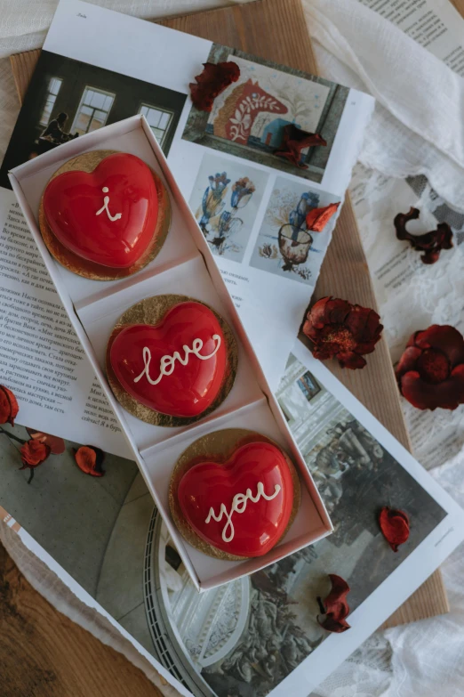 a box of valentine cupcakes with love written on the bottom and inside